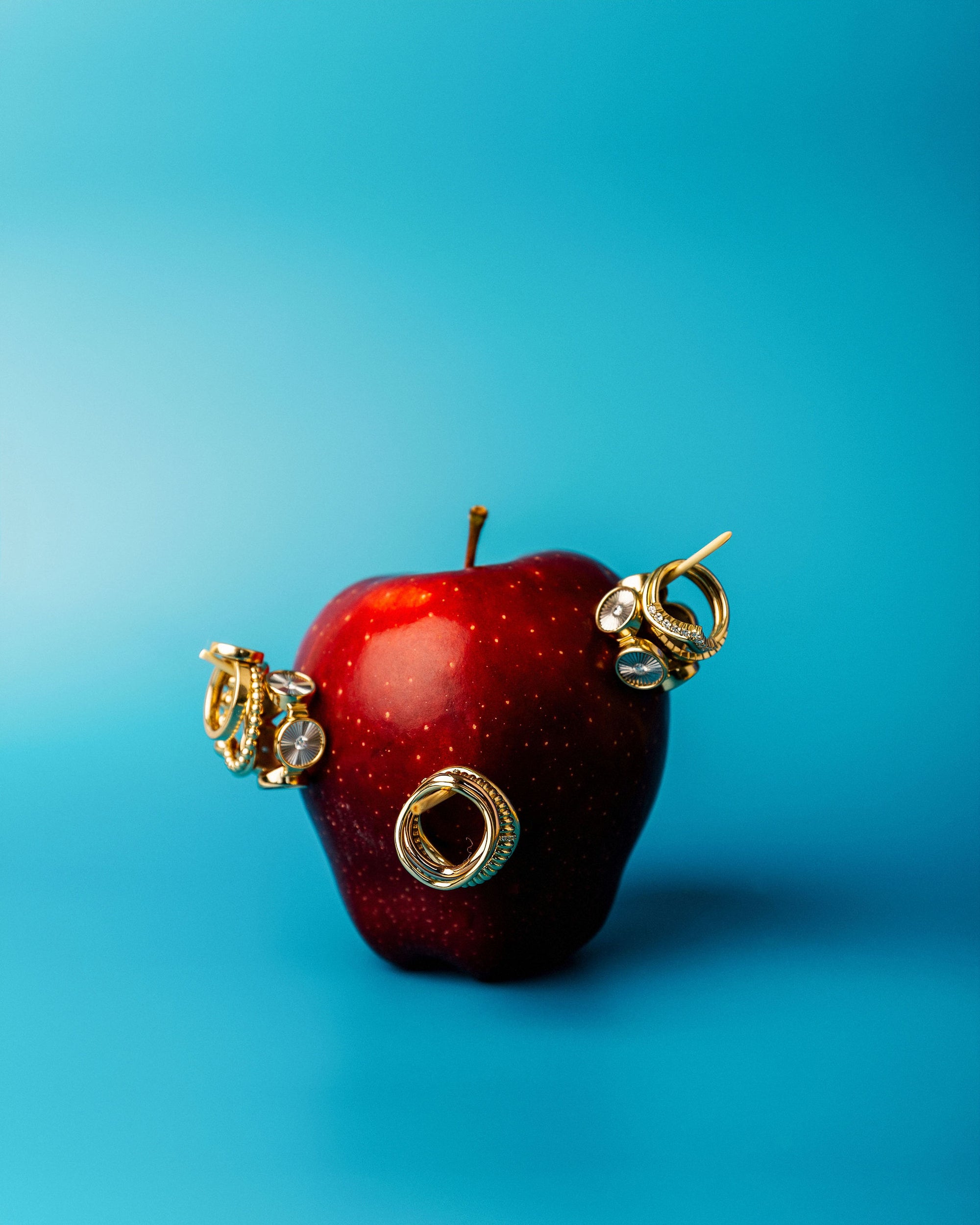 Bondeye Jewelry Spring shoot Gala Apple with Rings stuck onto it