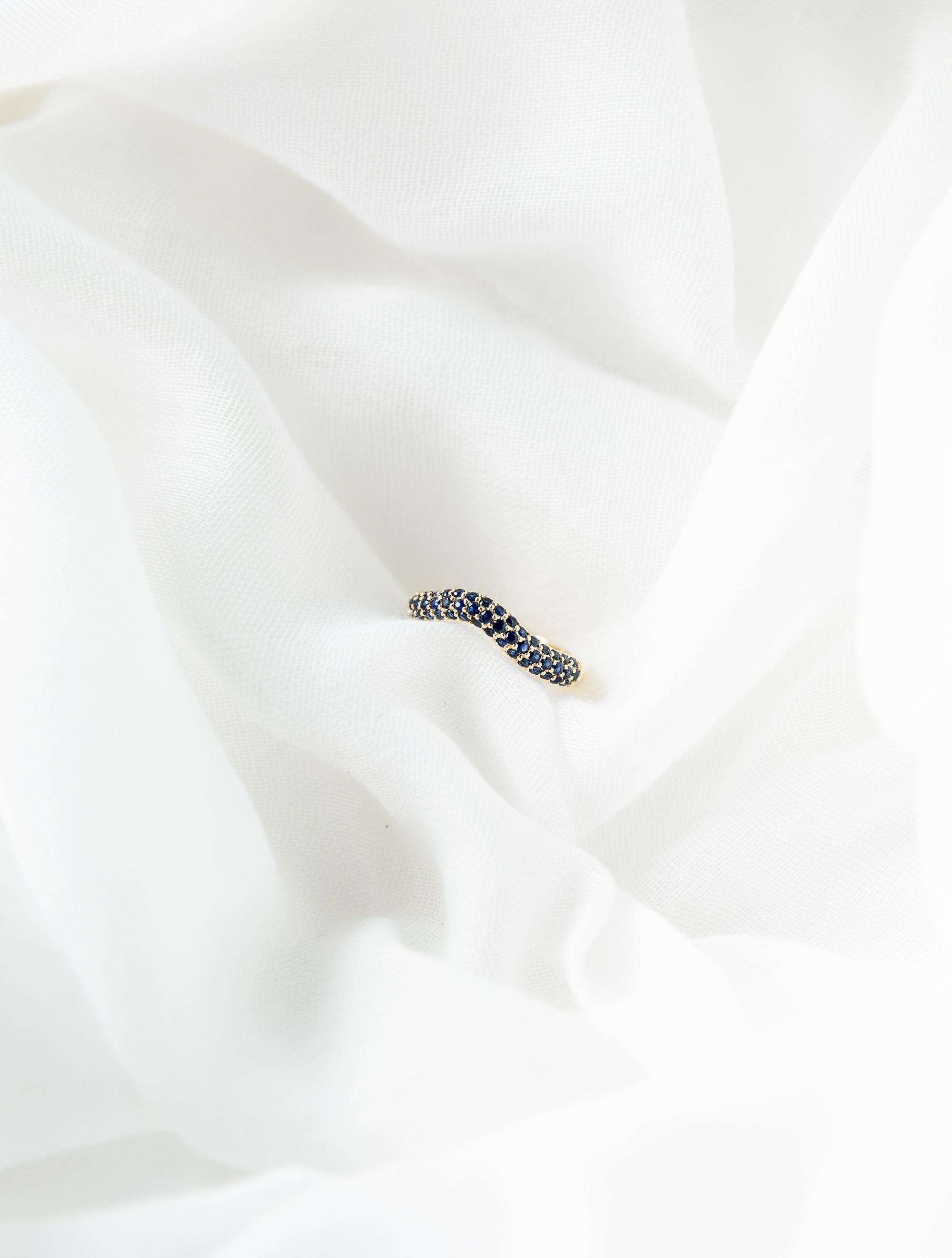 Beth Ring in 14K gold with pavé blue sapphires and wave design