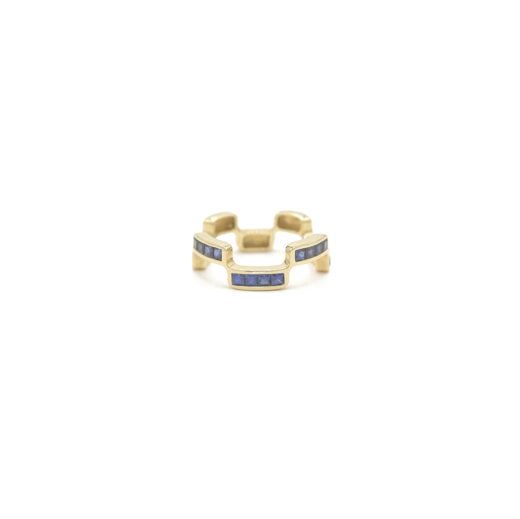 Puzzle Block Gold ring with blue sapphire gemstones on a white background