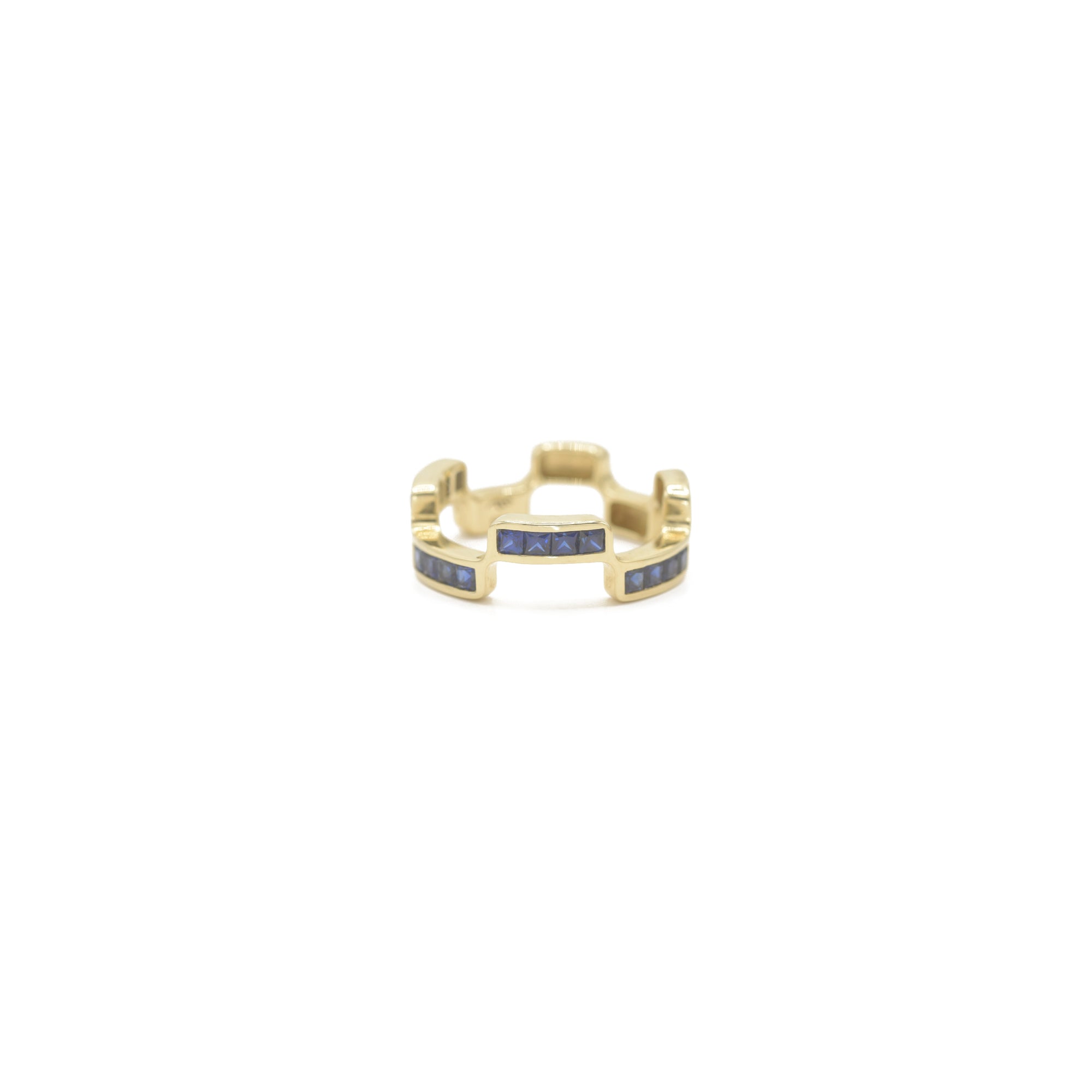 Puzzle Block Gold ring with blue sapphire gemstones on a white background