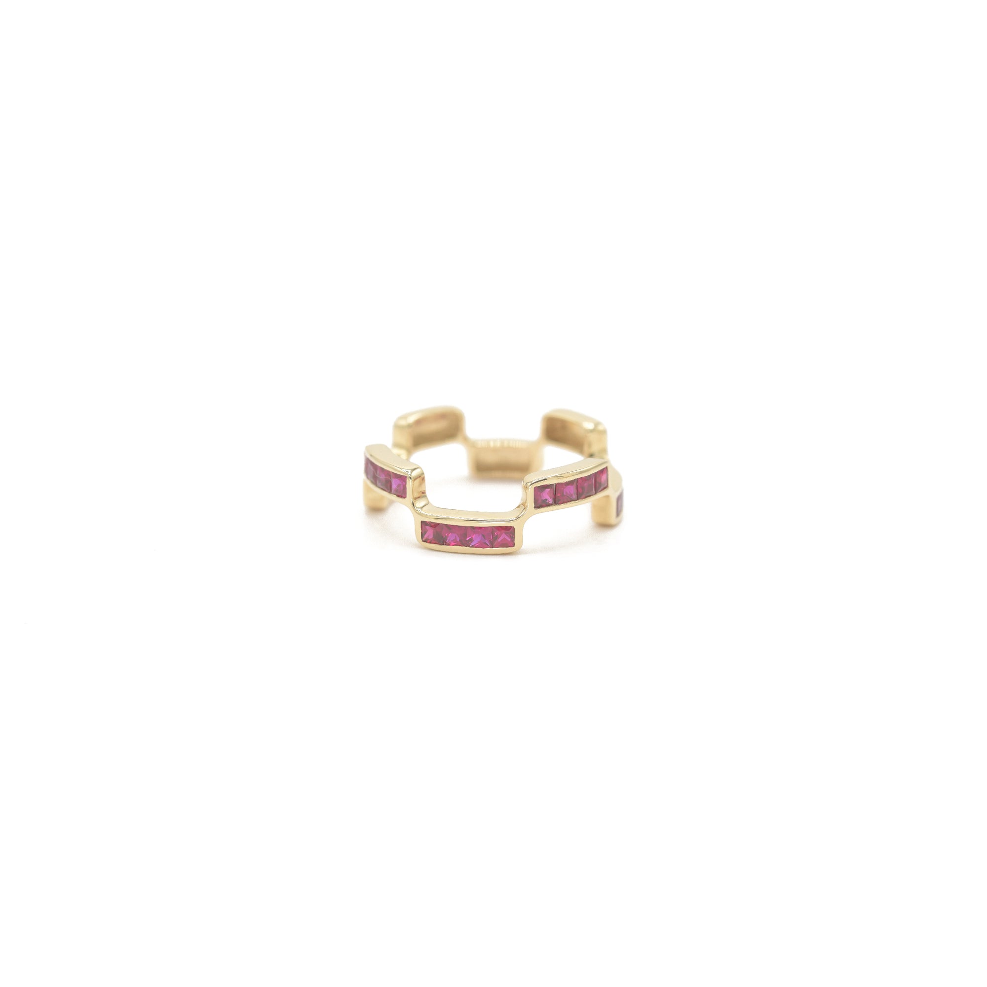 Puzzle Block gold ring with Ruby gemstones on a white background