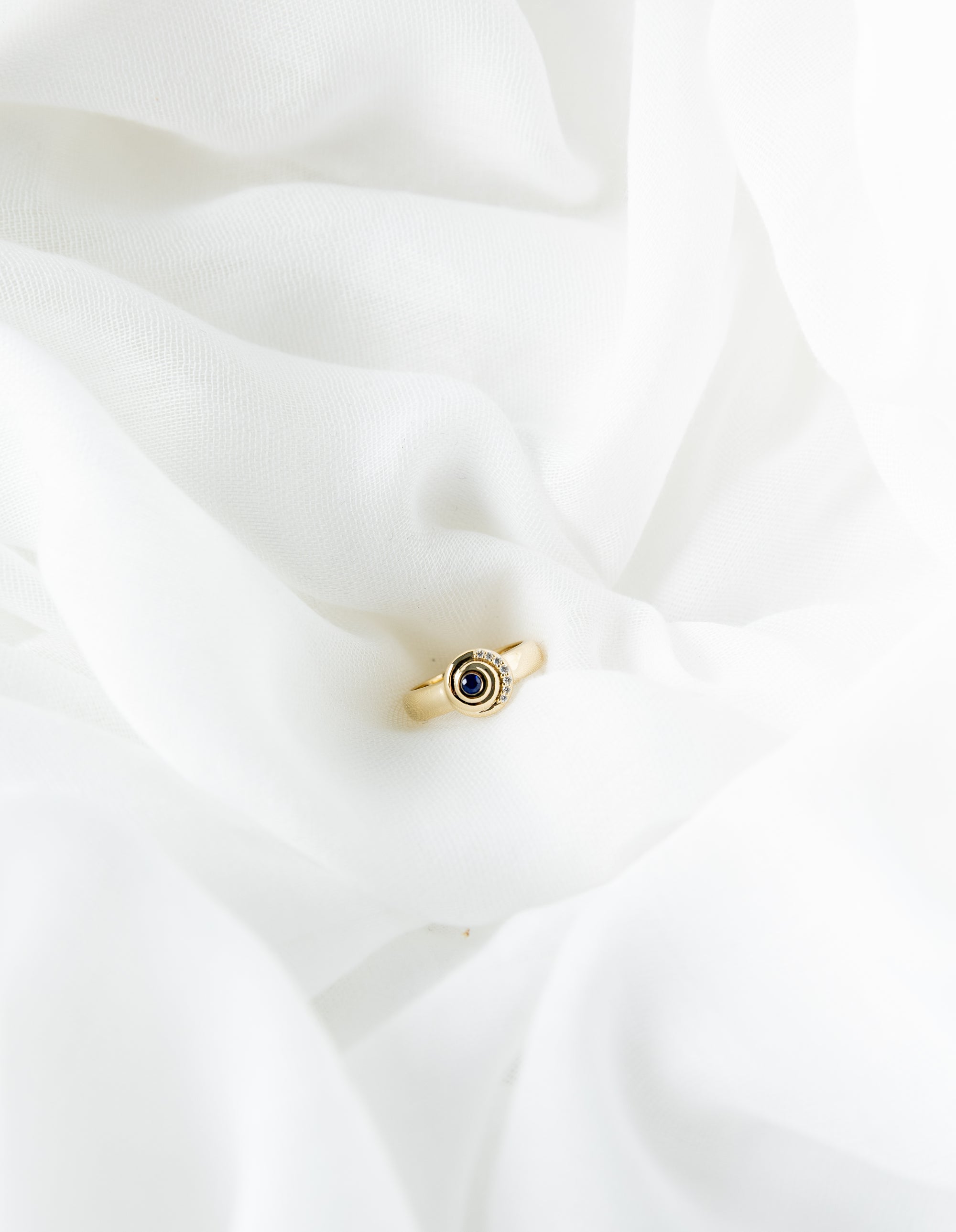 Khushi Ring in 14K yellow gold with spiral design and blue sapphires