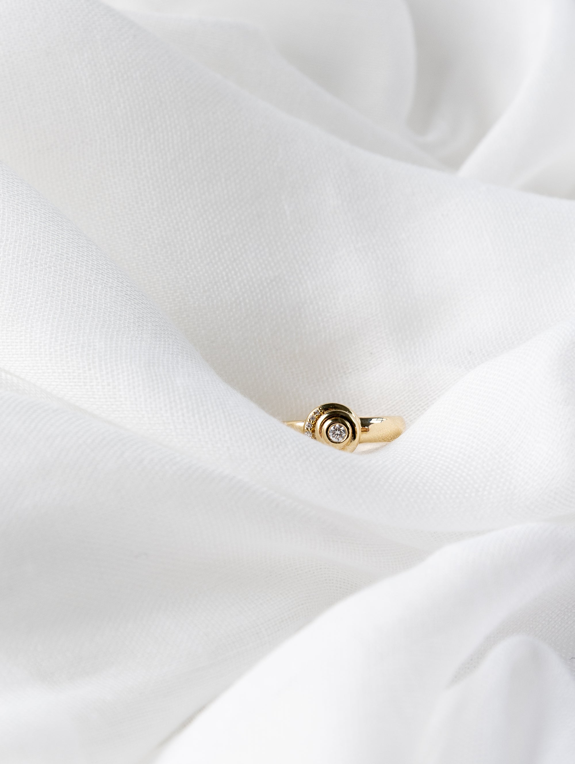 Khushi Ring in 14K yellow gold with spiral design and white diamonds