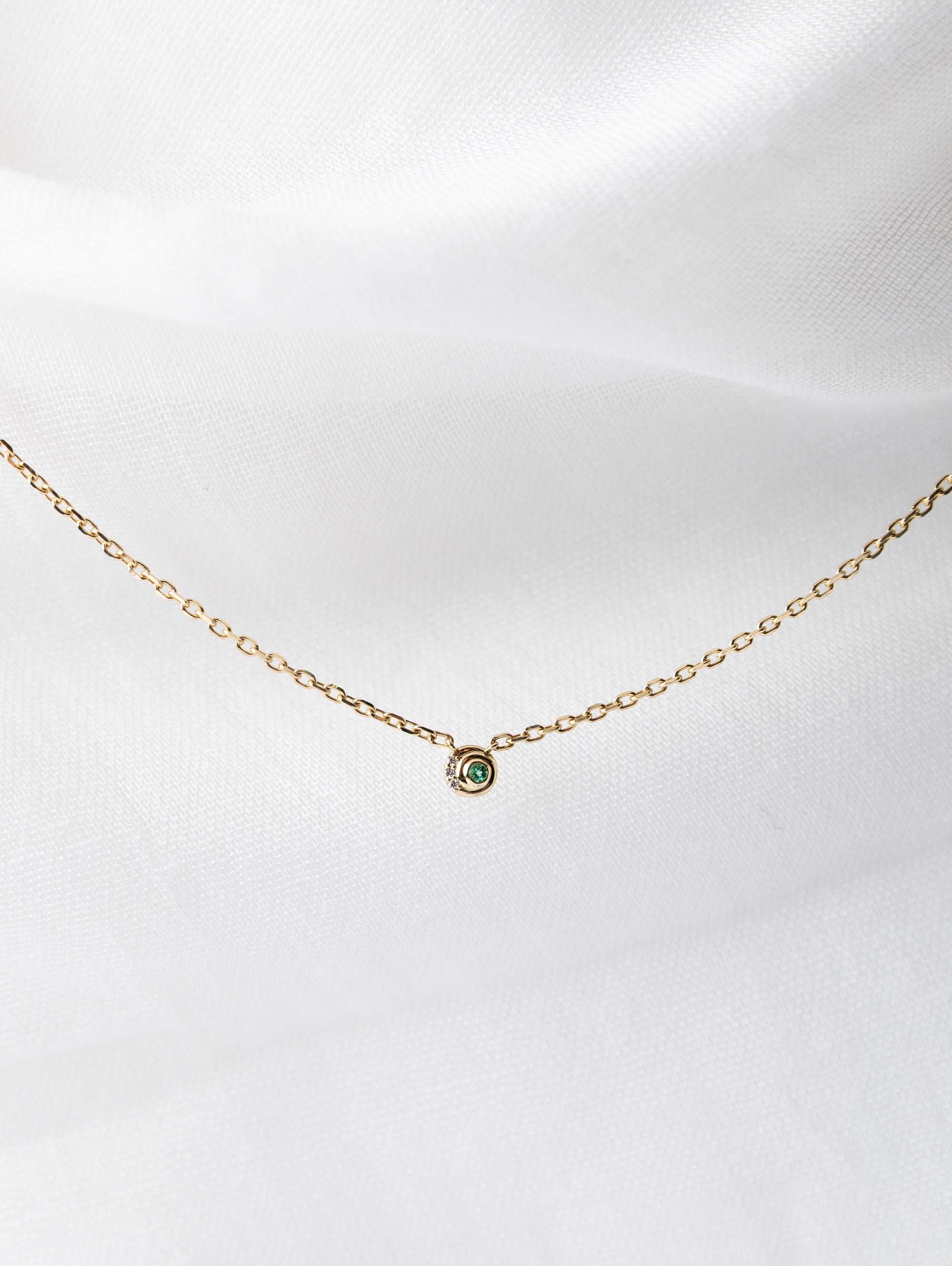 Nicole Necklace in 14K gold with spiral chain and white diamonds and emeralds