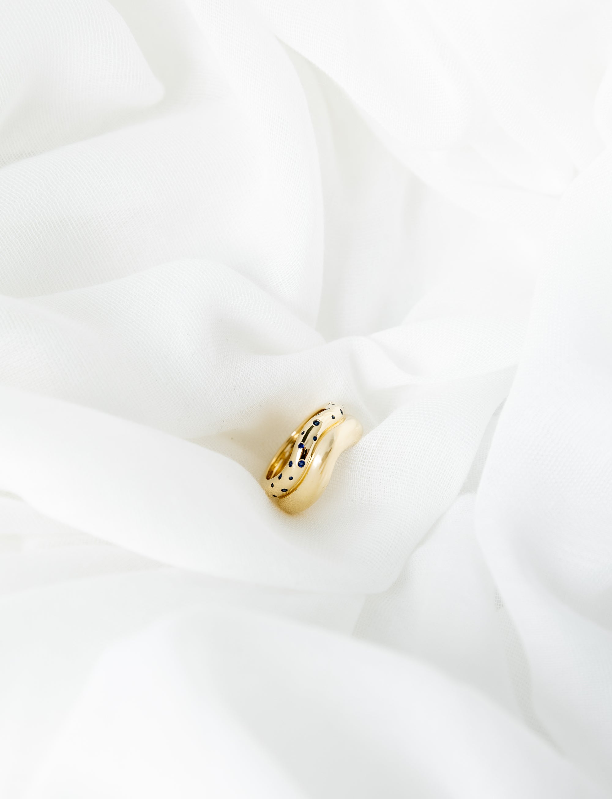 Shari Ring in 14K yellow gold with scattered blue sapphires and wave bands