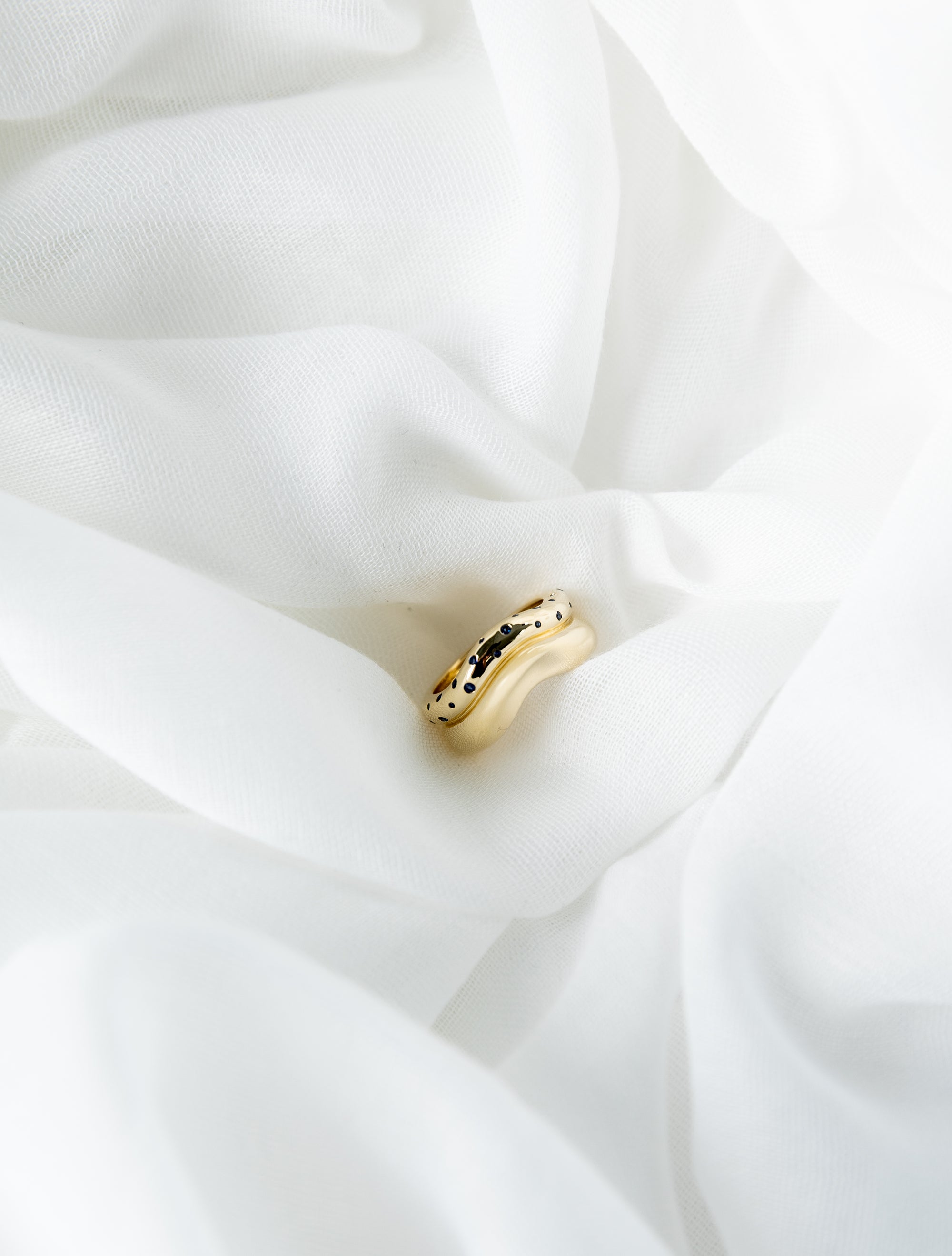 Shari Ring in 14K yellow gold with scattered blue sapphires and wave bands